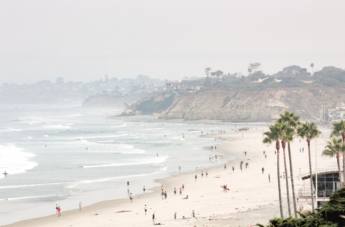 Photography by Kim Dybczak of: Del Mar Beach coastline appears in soft neutral tones along a wide, open shoreline.