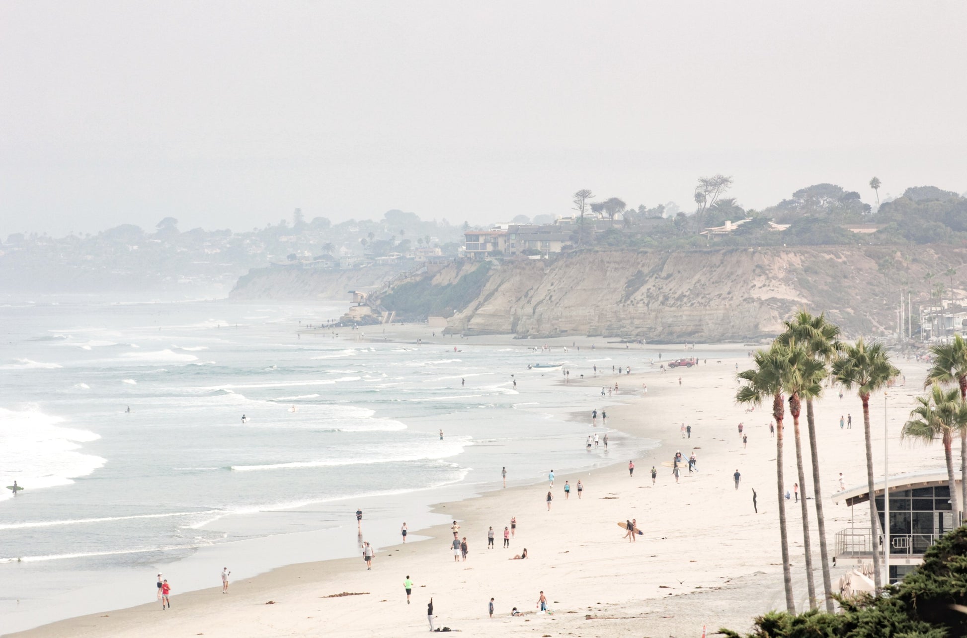 Photography by Kim Dybczak of: Del Mar Beach coastline appears in soft neutral tones along a wide, open shoreline.