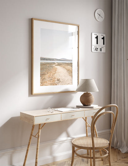 Framed photo of: Tomales Bay 7148 displayed above a desk in a neutral office.