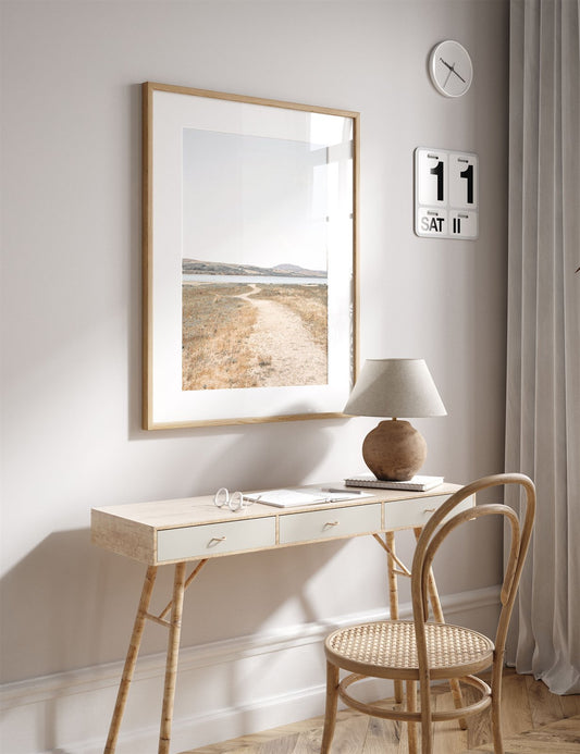 Framed photo of: Tomales Bay 7148 displayed above a desk in a neutral office.