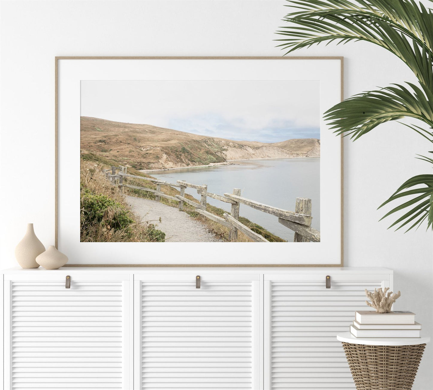 Framed photo of: Drakes Bay 7372 displayed above a white console.