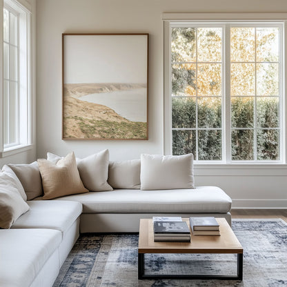 Framed photo of: Drakes Bay 7273 displayed above a couch in a modern coastal living room.