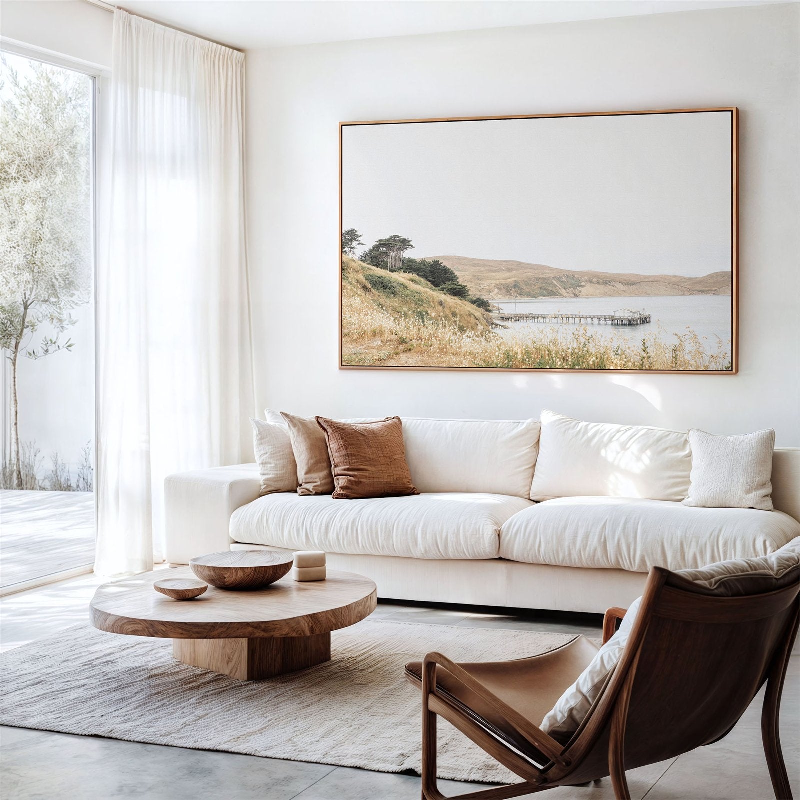 Framed photo of: Drakes Bay 7362 displayed above a couch in a modern neutral living room.