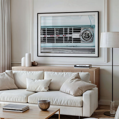 Framed photo of: Vintage Ford 7815 displayed above a couch in a living room.