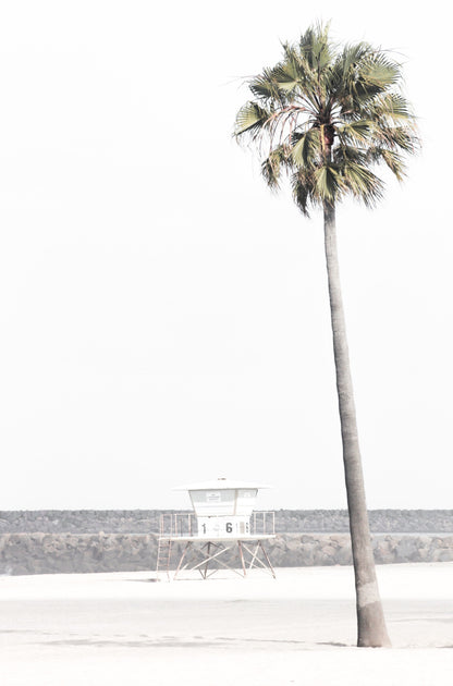 Photography by Kim Dybczak of: A California lifeguard tower set against calm water and open sky, softened by coastal haze.