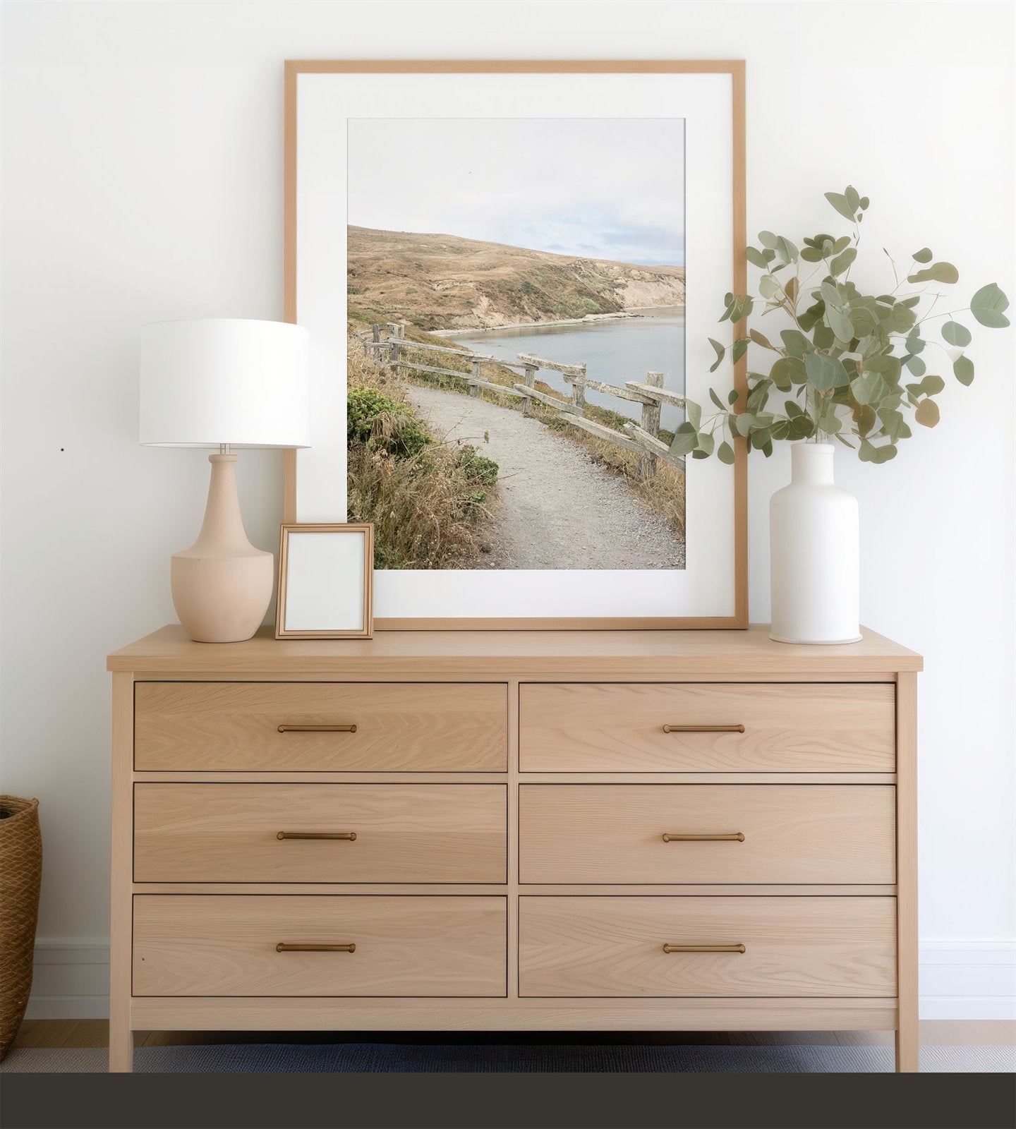 Framed photo of: Drakes Bay 7374 displayed above a modern dresser.