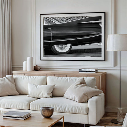 Framed photo of: Cadillac Fleetwood 7961 displayed above a couch in a modern living room. 