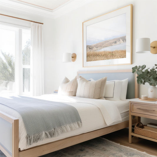 Framed photo of: Drakes Bay 7299 displayed above a bed in a coastal bedroom.