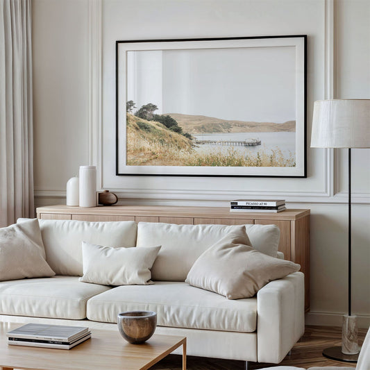 Framed photo of: Drakes Bay 7362 displayed above a couch in a modern living room.