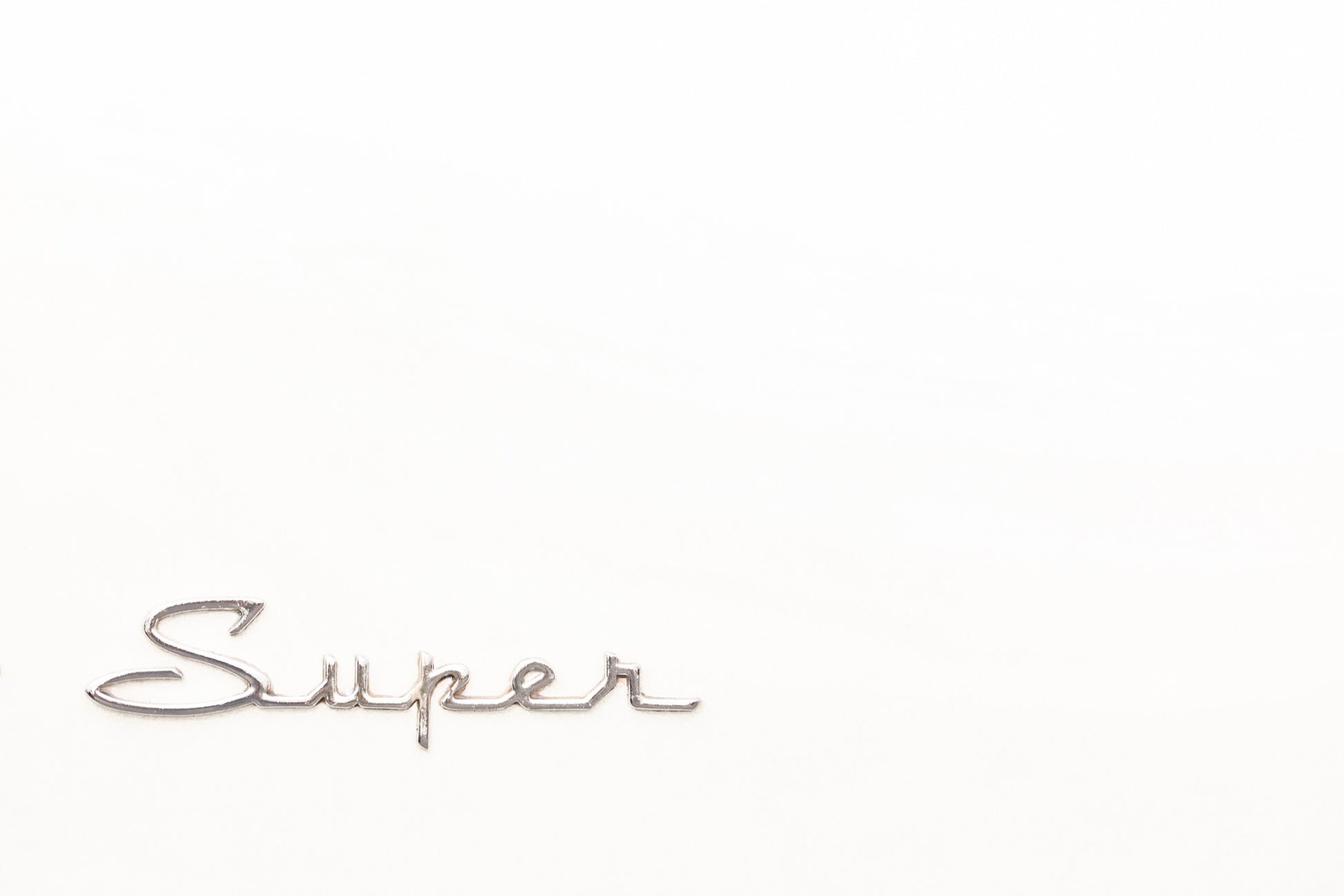 Photography by Salt Creek Prints of: Super 7772, Close up image of the Super logo from a classic Packard Clipper Super.