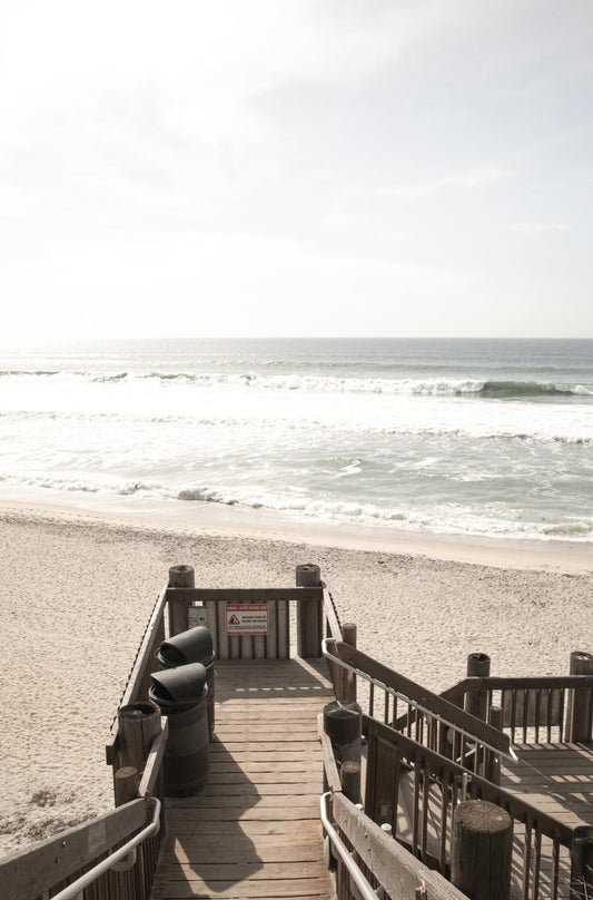 Photography by Kim Dybczak of: A stairway descends toward the beach, opening to a wide ocean view.