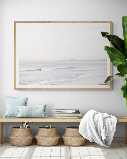 Horizontal minimalist ocean print showing a smooth seascape with gentle ocean waves meeting a clear horizon line. This calm ocean print provides a serene view. Photograph in minimalist mock up.