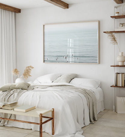 Horizontal surf art showing multiple surfers waiting in the calm ocean water for waves, with a hazy Southern California coastline in the distance. This minimalist surf print captures authentic surf vibes. Photograph in minimalist mock up.